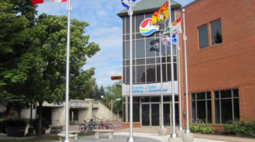 Atlantic Lottery Corporation headquarters building with flags